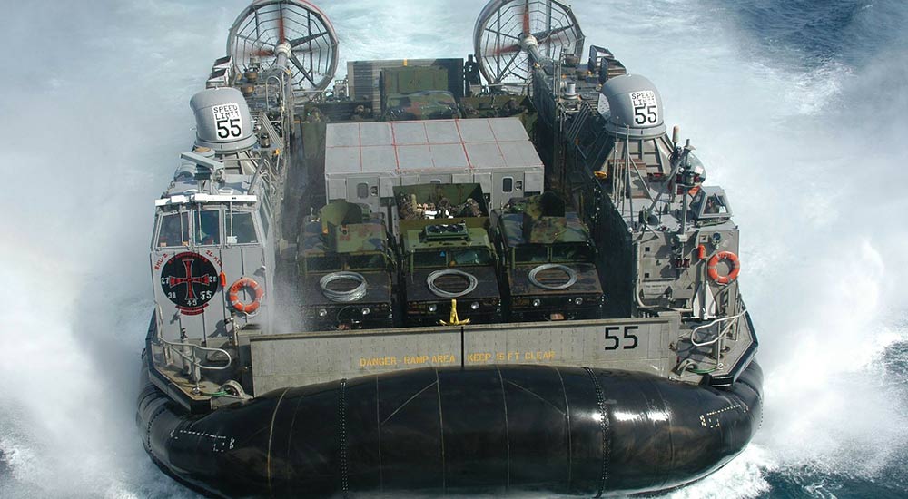 An amphibious hovercraft carrying hummers