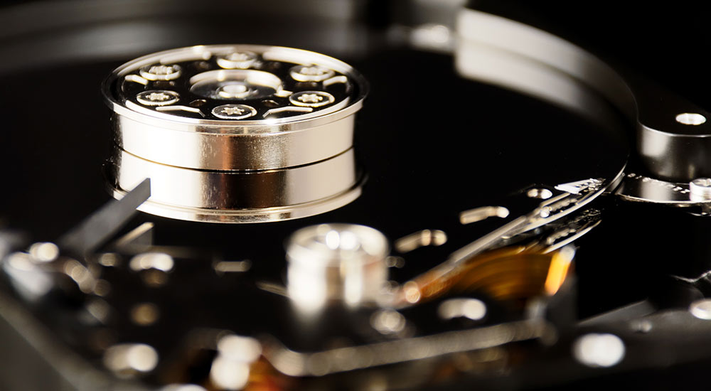 Photograph of a hard disk head and platter.